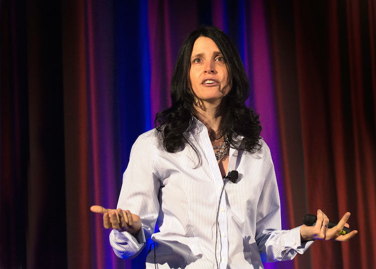 Dr. Julie Gurner speaking on stage